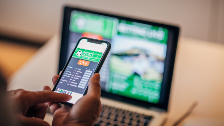 Staying ahead of the gambling act review - someone gambling on their phone